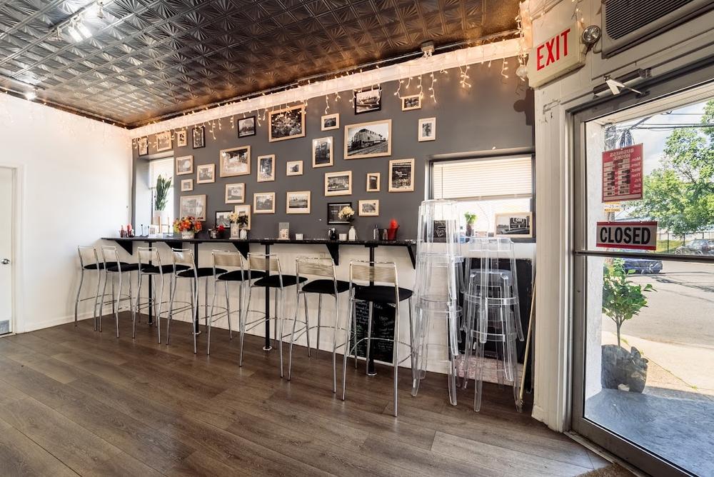 Haven Café's cozy dining counter with string lights and a wall of framed neighborhood photos.