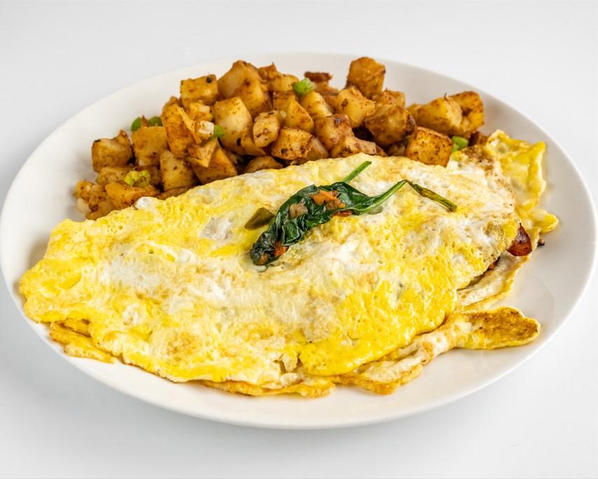 Western omelette with home fries, fresh off the griddle.